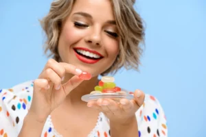 Woman Eating CBD Gummy for Better Sleep